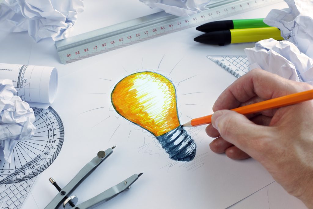 Designer drawing a light bulb symbolizing intellectual property in Milwaukee