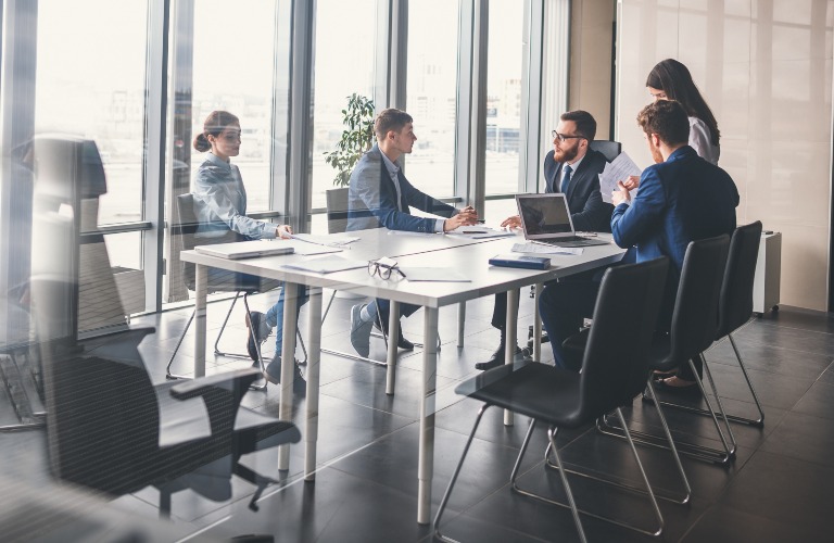 people sitting at a conference room table