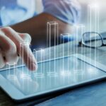 bar graph coming out of a tablet screen_s