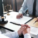 Lawyer with a gavel on desk reviewing paperwork_s