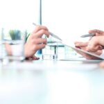 Two people working on paperwork_s