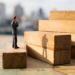 Man trying to make a high step on wooden blocks_s