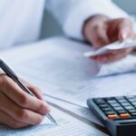 businessman makes calculations and fills out documents