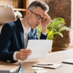 middle-aged businessman bills