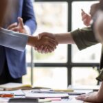 Business Team offer and give hand for handshake in office_s