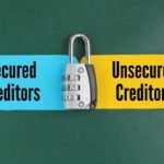 keys and colored paper with the words secured creditors and unsecured creditors_s
