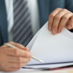 man in suit holding documents in his hands_s