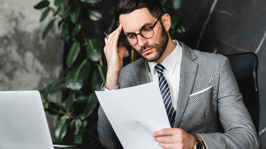 stressed businessman checking documents