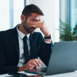 Frustrated, businessman or headache with laptop for stress, mistake or corporate bankruptcy_s